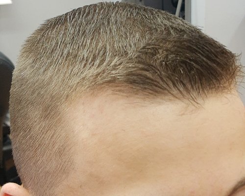 Tight fade on sides, scissor cut on top and flip in the front.