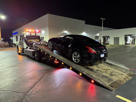 Towing a low clearance car using a low profile flatbed tow truck