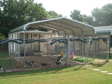 Small dog boarding house with shaded canopy.