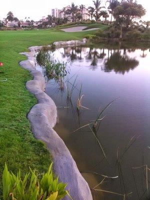 Completed Riprap retaining wall on golf course water hazard.