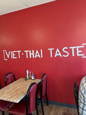 Wall painted red with white letters Viet-Thai Taste