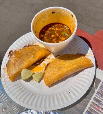 Birria tacos with complementary consommé.