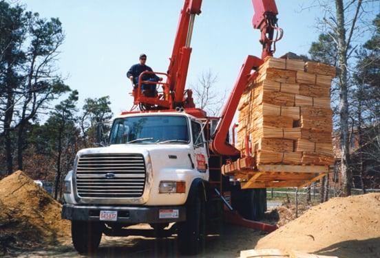 Mid-Cape Home Centers job site delivery fleet - boom trucks, tractor trailers, truck-mounted forklifts, flat beds & box trucks.