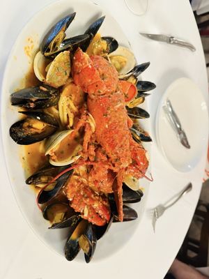 Whole lobster over bucatini spaghetti with mussels and clams