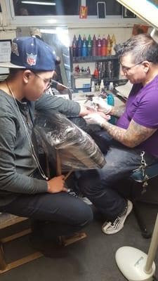 My son getting his 1st tattoo by the best.