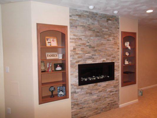 Custom Built in bookcases with gas fireplace in basement