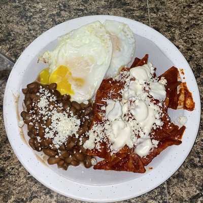 chilaquiles in red salsa with eggs over easy and beans | chilaquiles en salsa roja con huevos y frijoles