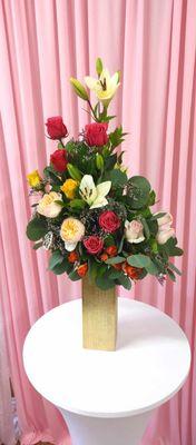 A bouquet springled with red & orange roses, with peach garden roses