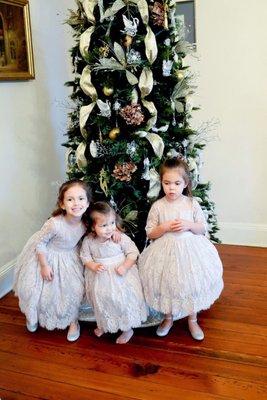 Three little beauties in front of the Christmas tree.