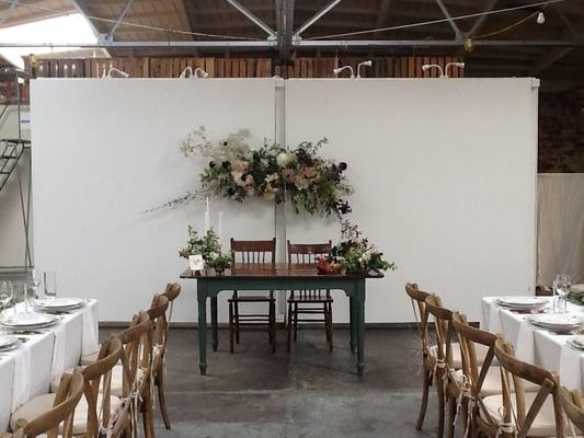 A view of the oh so romantic sweetheart table using a farm table.