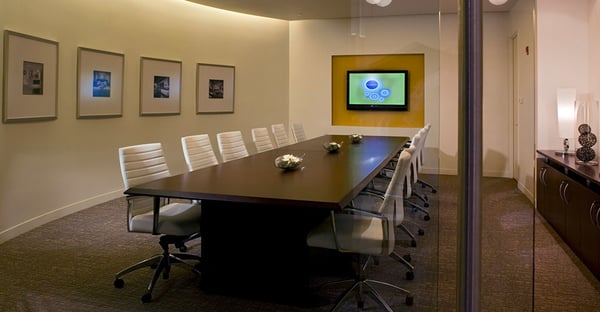 Modern white leather conference room chairs and wood boardroom tables.