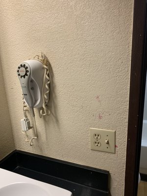 Stains on wall. I'm not sure if that's a hair dryer or what, but it's clearly beyond outdated!!!!!