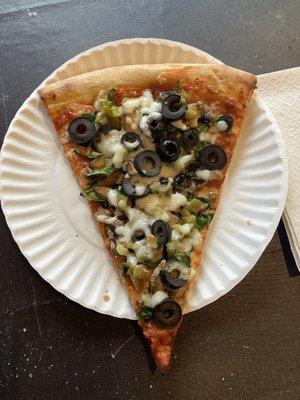 Specialty Slice with mushrooms, black olives, green peppers, and spinach