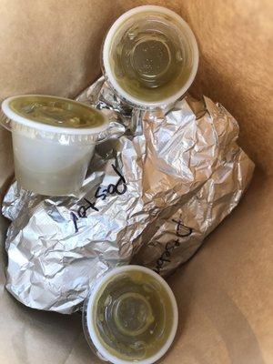 To-go tacos individually wrapped and labeled with free homemade medium and spicy sauces