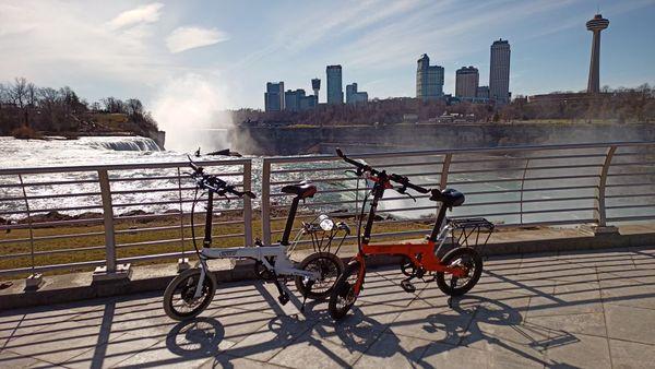 our eBikes at Niagara Falls State Park's at the Discovery Center with Niagara Falls, Canada in the background