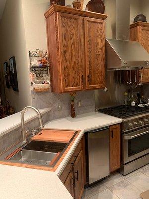 Sink trim matches cabinet refinishing done by Trey.