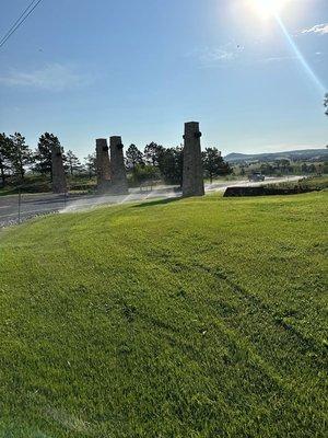 In summer's heat, we're adjusting the sprinkler systems to ensure the grass stays green and healthy.