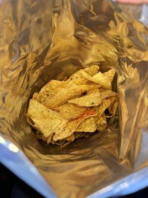 Naked tortilla chips that are supposed to be full of Chile ( defected chip bag )