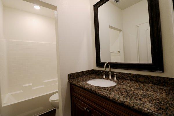 Luxurious Bathrooms with Granite Countertops, Beautiful Mirrors, Upgraded Cabinets and Plumbing Fixtures