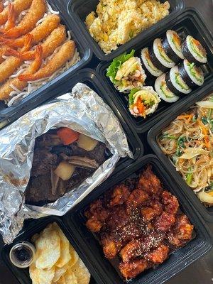 Clockwise: Fried Shrimp, Fried Rice, Kimbap, Japchae (glass noodles), sweet sour chicken, fish pancakes, and Galbijim!!