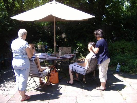 some Reiki students of mine sharing Reiki during a class outside on my patio outside of my Center