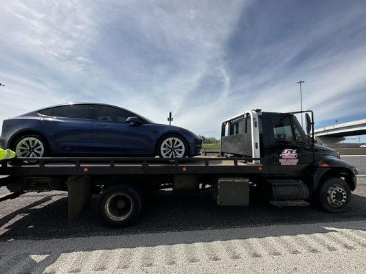 L&L Towing helping a customer by towing his Tesla