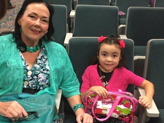 A baptized servant bringing her granddaughter. Everyone gets to sit together.