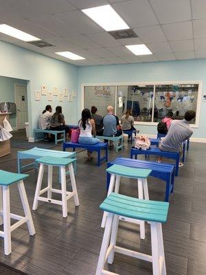 Waiting area for parents looking at swimming pool.