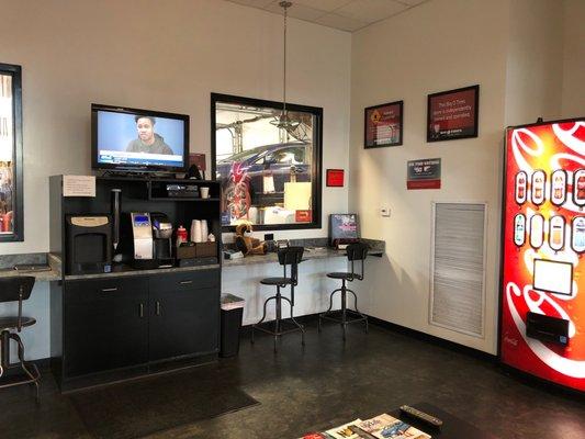 Waiting area with free coffee and viewing window so you can watch your car being worked on