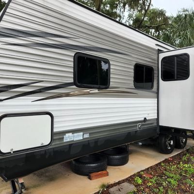 Pressure wash rv from roof to concrete.