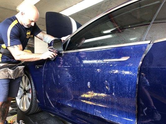 Lou from Automotive Shield applying XPEL Ultimate Plus paint protection auto wrap to Tesla 3