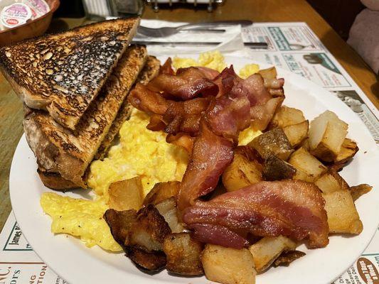 Breakfast #2: 3 eggs, bacon, home fries and toast. A hearty delicious breakfast