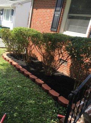 Add stone edging including black mulch