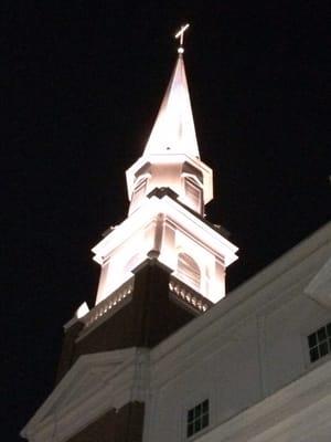 Photo of the church steeple at night.