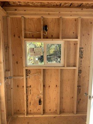 Custom window framed into shed