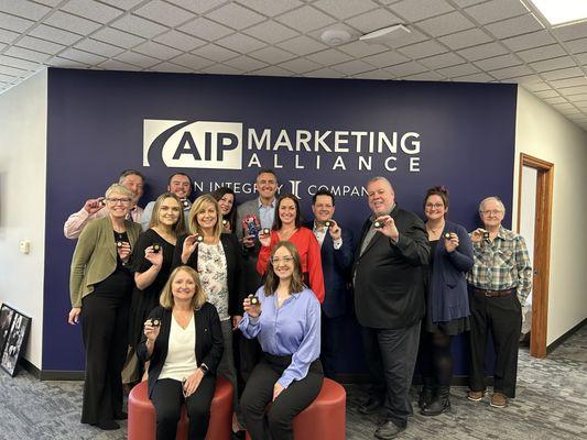 AIPMA's employees show off their Integrity pins (][) during our 2024 pinning ceremony.