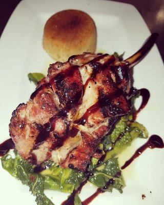 Grilled veal chop over broccoli rabe