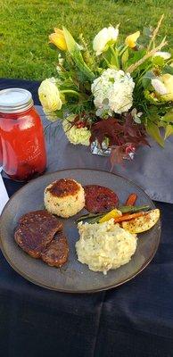 One serving of Filet Minion, Crab cake, mashed potatoes & seasonal vegetables. The delicious jar is blackberry lemonade.