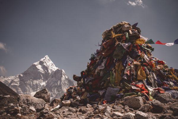 A mountain of trash set against a view of a mountain