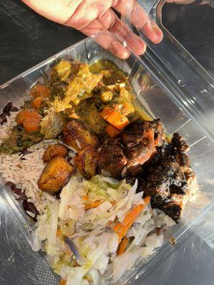 Curry goat and jerk chicken combo, served with rice and peas, fried plantains, and steamed cabbage