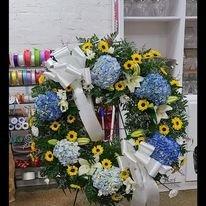 Wreath: Blue Hydrangeas, White Lilies with some yellow Viking poms