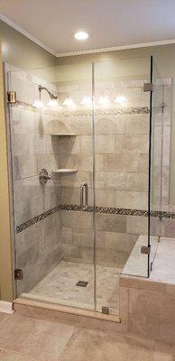 Custom shower glass enclosure with hardware. Nice open space for this beautiful shower.