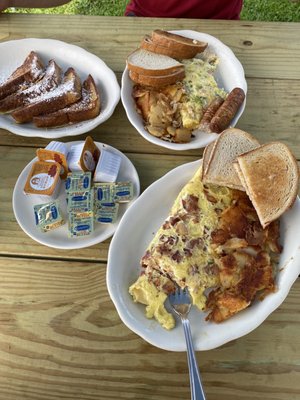 Bacon/ cheese omelette & western omelette with home fries and rye toast with a side of sausage links and French toast.