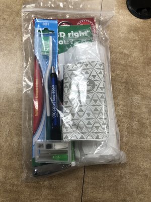 Welcome kit with Kleenex, toothbrush, pen, pill container, nail clippers, glasses repair kit, informational fliers