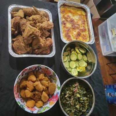 Fried chicken, setved with Au gratin potatoes  potatoes, collard greens, sweet potatoes  and a squash medley.