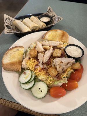 Grilled chicken salad and a side of their egg rolls.