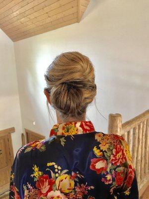 Low twisted updo design for bridesmaid