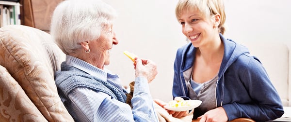 Loving caregiver with a happy client.