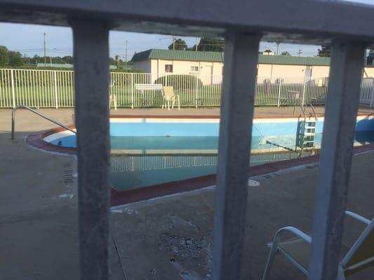 Swimming pool was half empty and brown.