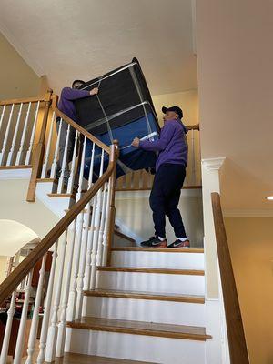 Carmel Movers carrying items down stairs